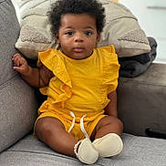 Eden participe au concours pour gagner de l'argent avec cette photo : baby, child, yellow_clothing, sitting, couch, pillow, indoor, curly_hair, footwear, home, cute, portrait, expression, infant, furniture, relaxing, comfort, cozy, person, casual
