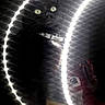 animal, black_cat, cat, close_up, collar, dark_background, dramatic_lighting, glowing_lights, green_eyes, indoor, mirror, mysterious, perfume_bottle, pet, photography, portrait, reflection, ring_light, sitting, whiskers