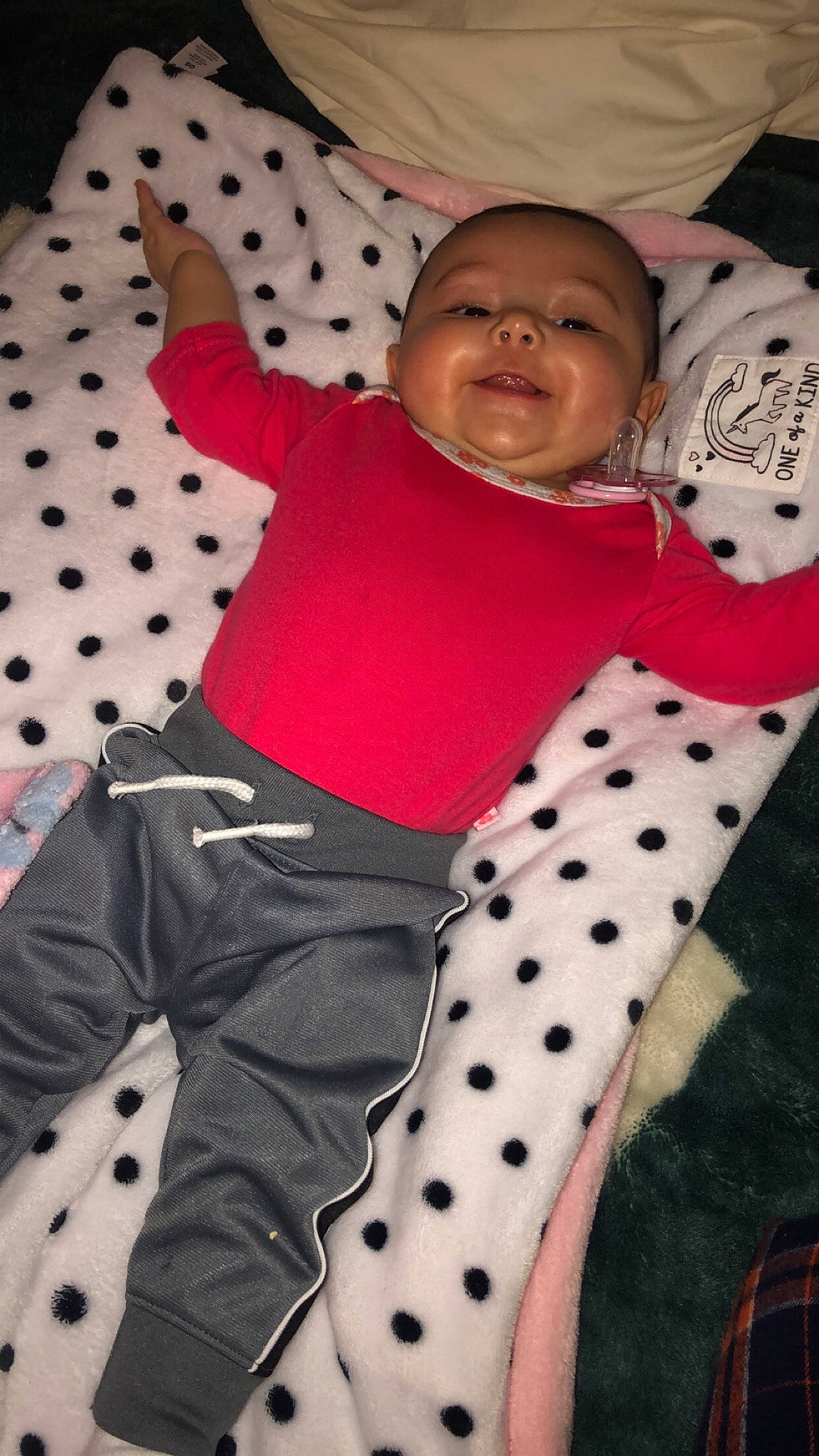 Amiah is registered to the contest to win money with this photo: beauty, child, day, design, facial_expression, fun, girl, human, infant, organ, pattern, person, pink, plaid, product, red, sitting, skin, smile, textile