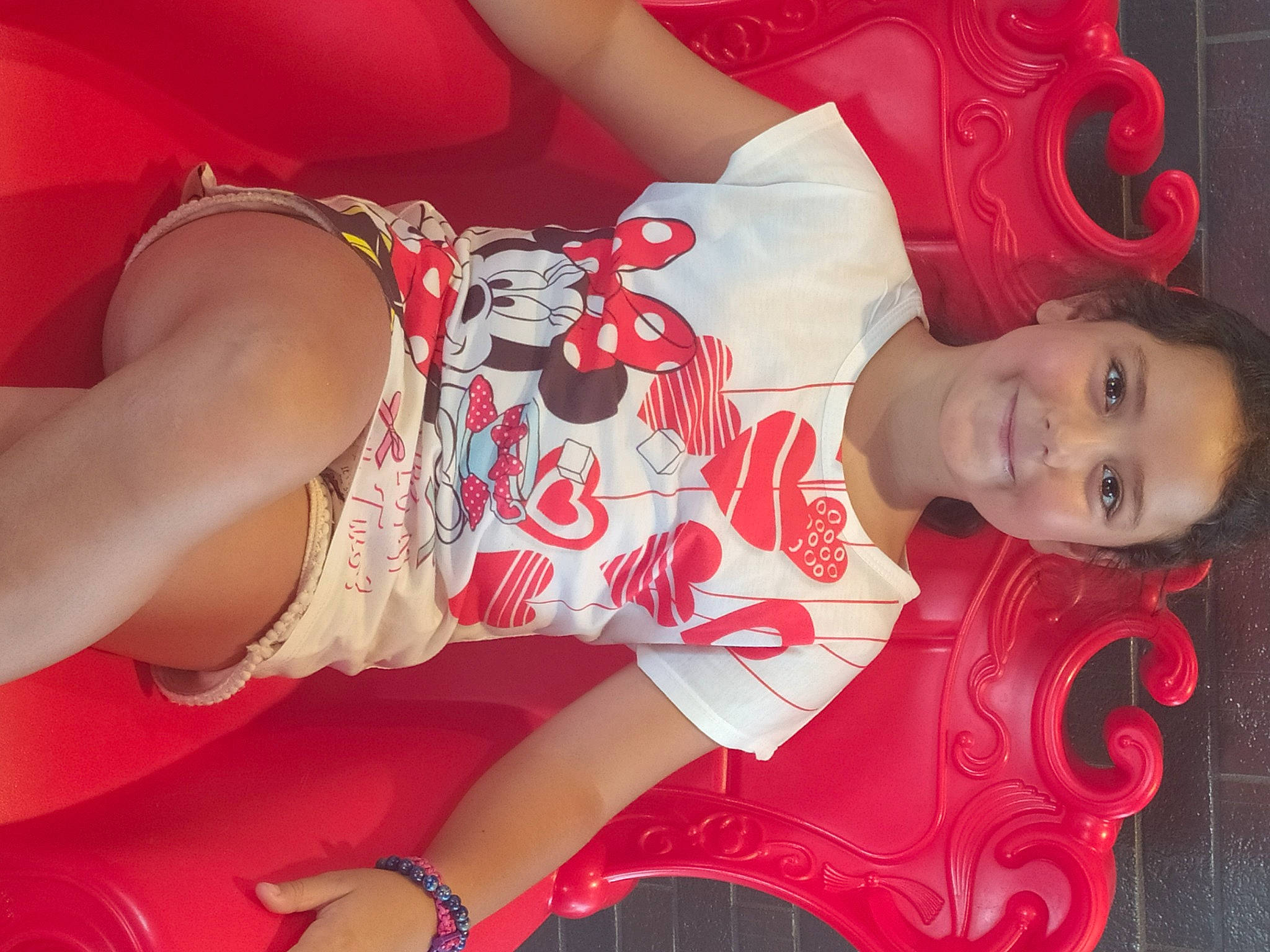 Ilona participe au concours pour gagner de l'argent avec cette photo : abdomen, black_hair, chest, dress, happy, human_leg, joint, joy, leg, lip, long_hair, neck, pattern, person, pink, red, skin, textile, thigh, trunk