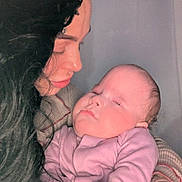 Adorabella is registered to the contest to win money with this photo: baby, sleeping, woman, holding, curly_hair, pink_clothing, tattoo, close_up, indoor, love, peaceful, face, portrait, skin, hand, person, family, mother, child, gentle