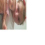 Ella is registered to the contest to win money with this photo: baby, child, woman, face, hair, red_hair, pink_clothing, hand, indoor, bed, blanket, skin, portrait, cuddle, family, resting, casual, young, person, closeup