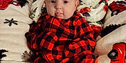 Adalynn joined the competition — help win amazing prizes! baby, black, blanket, checkered, child, cozy, cute, decor, face, furniture, holiday, home, indoors, infant, pajamas, person, red, soft, tongue, warm