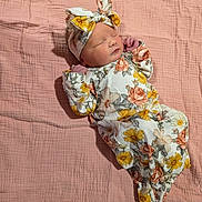 Mylah joined the competition — help win amazing prizes! newborn, baby, sleeping, floral_outfit, headband, pink_blanket, soft_texture, infant, peaceful, cute, portrait, child, sleep, wrapped, resting, indoors, cozy, adorable, small_hands, peace