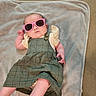 Elaina joined the competition — help win amazing prizes! baby, child, sunglasses, pink_sunglasses, dress, green_dress, blanket, carpet, floor, infant, laying_down, cute, fashion, portrait, person, indoor, small_child, headwear, foot, hand