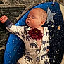 Blue is registered to the contest to win money with this photo: baby, sleeping, onesie, elephant_pattern, flower, purple_flower, star_pattern, blue_mat, infant, child, cute, peaceful, resting, indoors, soft_lighting, portrait, closeup, sleep, newborn, cozy