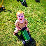 Henry is registered to the contest to win money with this photo: child, toddler, red_hair, blue_eyes, toy_tractor, grass, outdoor, sunny, happy, smiling, brown_shoes, shorts, short_sleeve, play, green_toy, summer, daylight, person, fun, nature