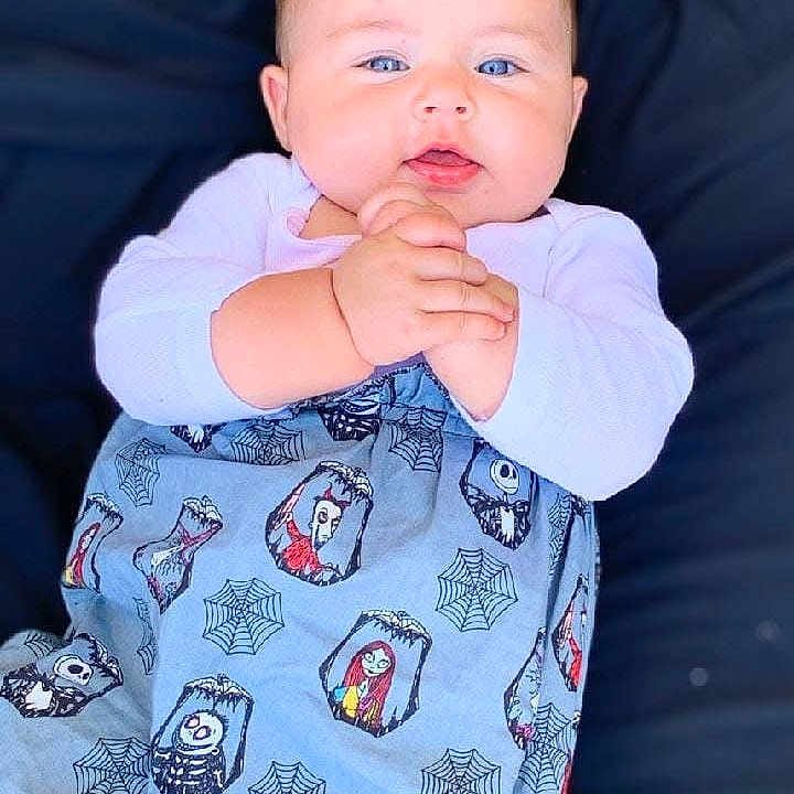 Nova joined the competition — help win amazing prizes! baby, blanket, blue_eyes, cartoon_characters, child, clothing, cozy, cute, face, hands, indoors, infant, lying_down, portrait, skin, smiling, soft_surface, spider_webs, wrapped, young