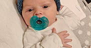 Oryan joined the competition — help win amazing prizes! baby, infant, pacifier, hat, knitted_hat, blue_hat, blanket, white_clothing, lying_down, hand, face, head, cute, soft_texture, indoors, newborn, sleepwear, resting, child, person