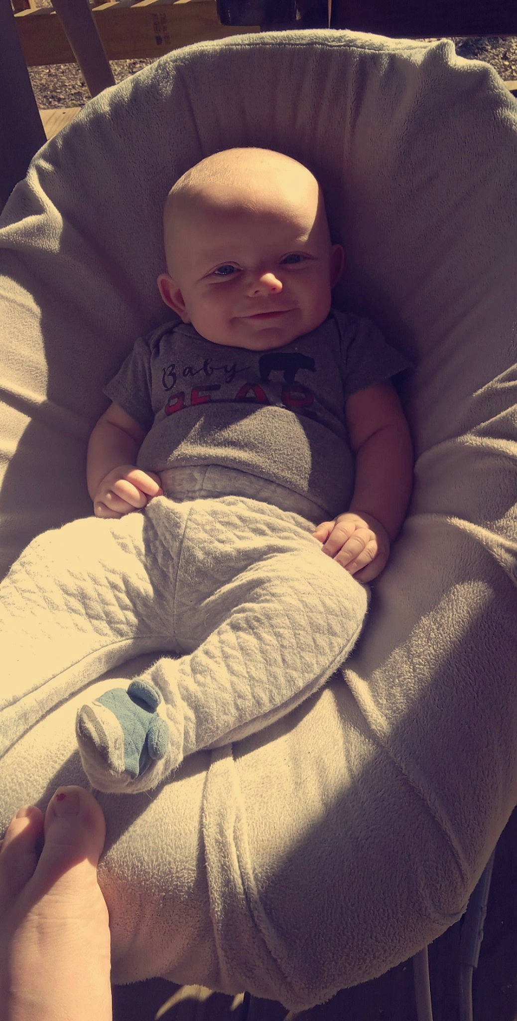 Braylon is registered to the contest to win money with this photo: baby, baby_toddler_clothing, cheek, child, comfort, darkness, foot, fun, fur, human_leg, lap, leg, linens, person, room, sandal, sitting, square, tints_and_shades, toddler