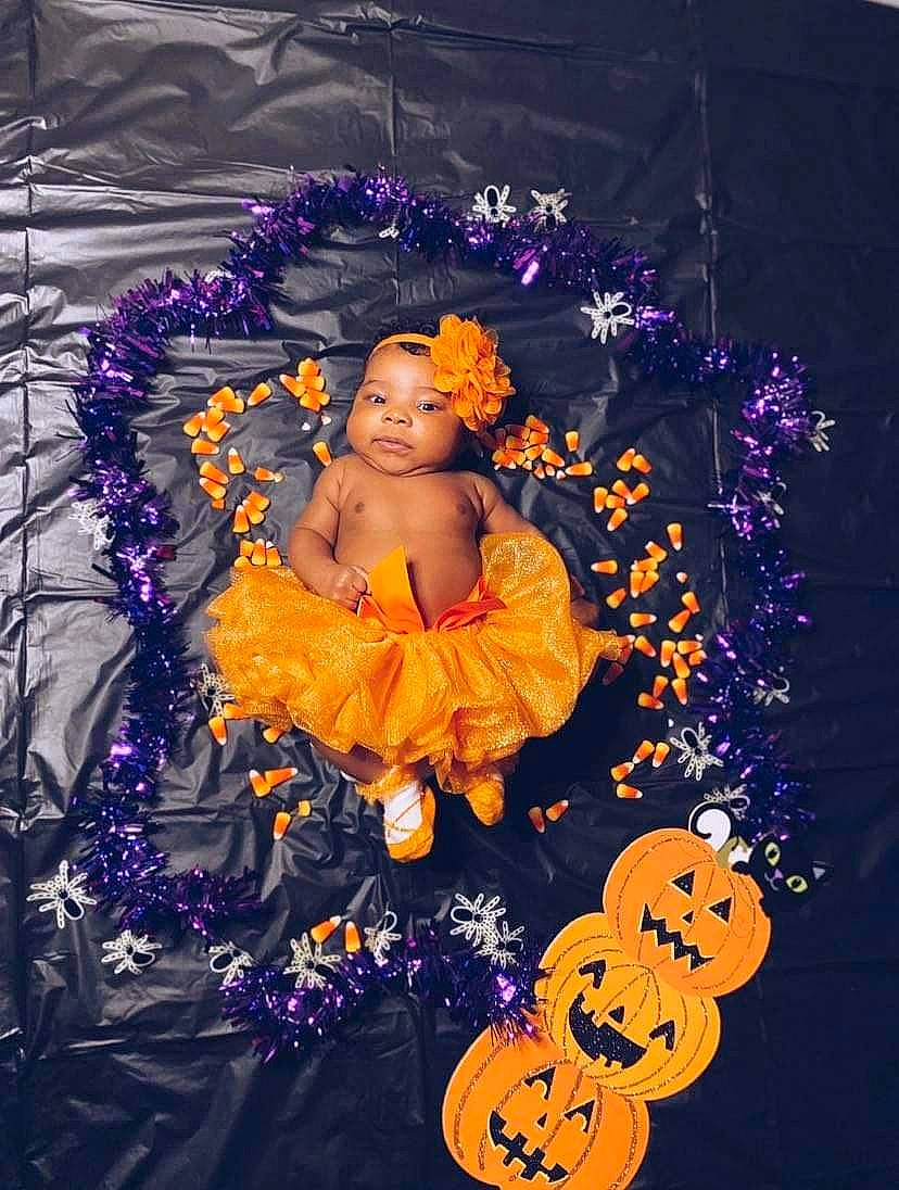 Kiara is registered to the contest to win money with this photo: art, baby, electric_blue, event, fictional_character, floral_design, flower, flower_arranging, headwear, illustration, interior_design, painting, person, picture_frame, purple, ritual, still_life_photography, toddler, tradition, violet