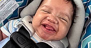 Azaryee joined the competition — help win amazing prizes! baby, blue, car_seat, child, closeup, clothing, cute, face, geometric_pattern, happy, headrest, indoors, infant, joyful, pattern, person, safety, seatbelt, smiling, straps