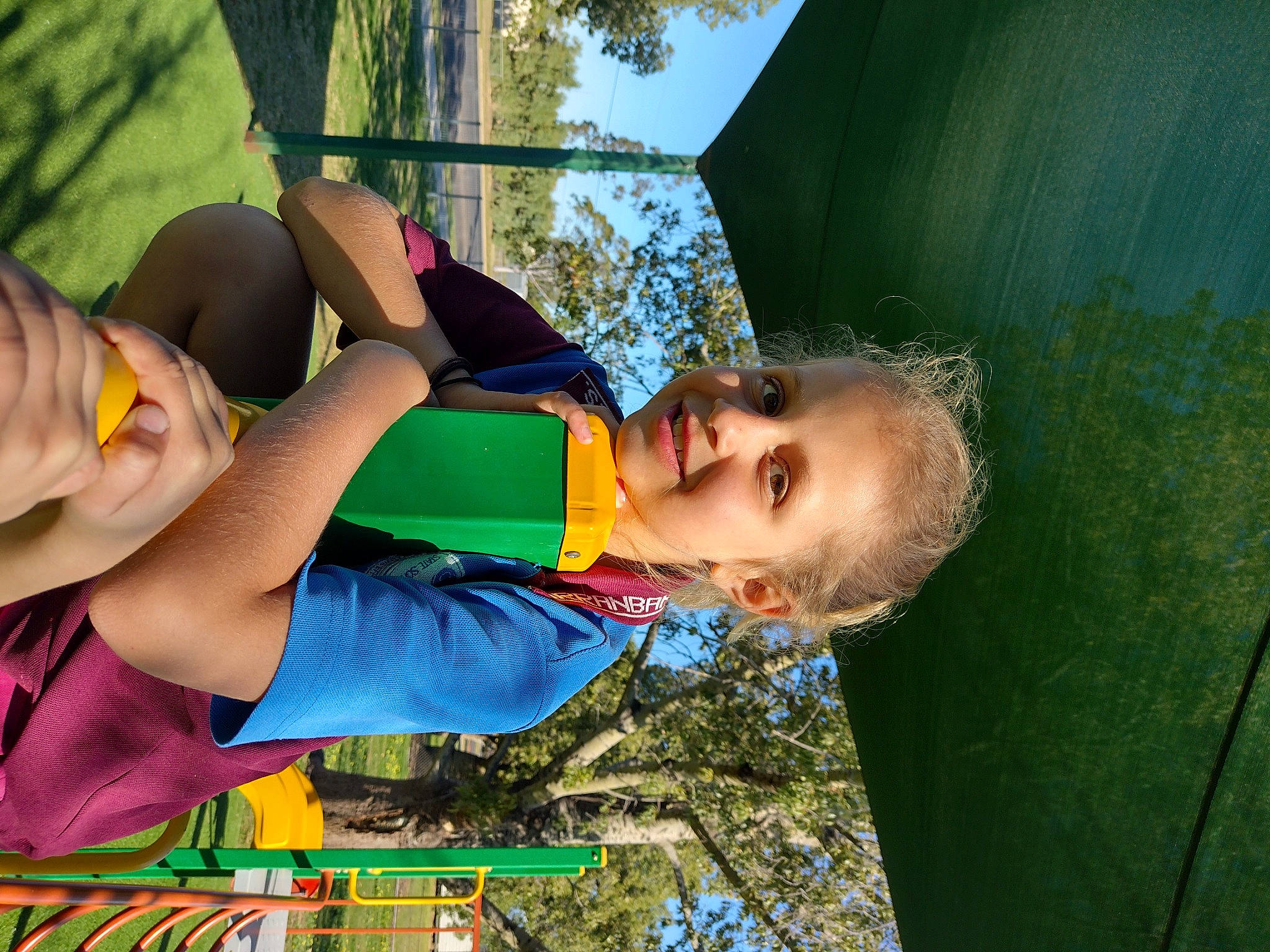 Meagan is registered to the contest to win money with this photo: abdomen, arm, child, electric_blue, eyewear, fun, grass, happy, joy, leisure, outdoor_play_equipment, people_in_nature, person, plant, play, recreation, shade, smile, t_shirt, thigh
