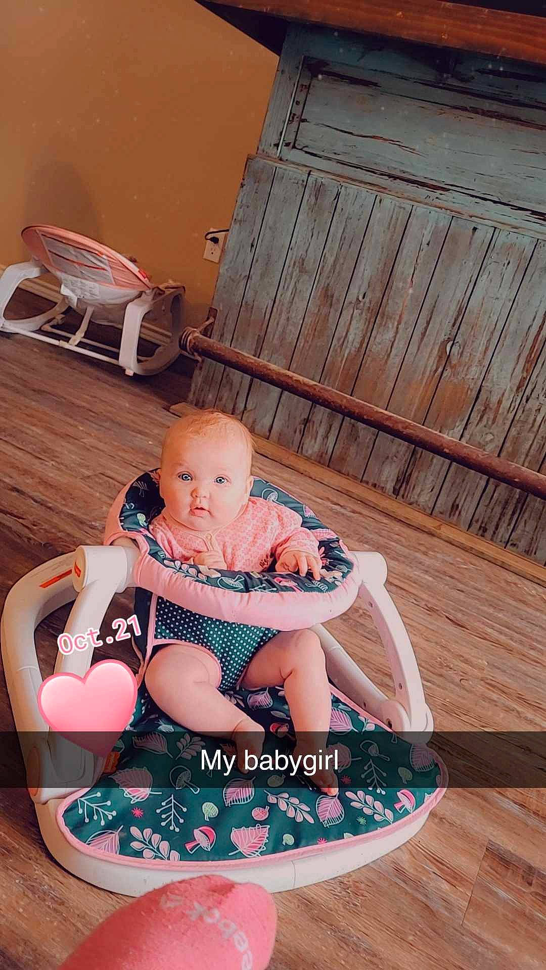Avery is registered to the contest to win money with this photo: baby, baby_products, baby_toddler_clothing, chair, child, comfort, flooring, foot, fun, hardwood, lap, leisure, outdoor_furniture, person, room, sitting, sock, thigh, toddler, wood