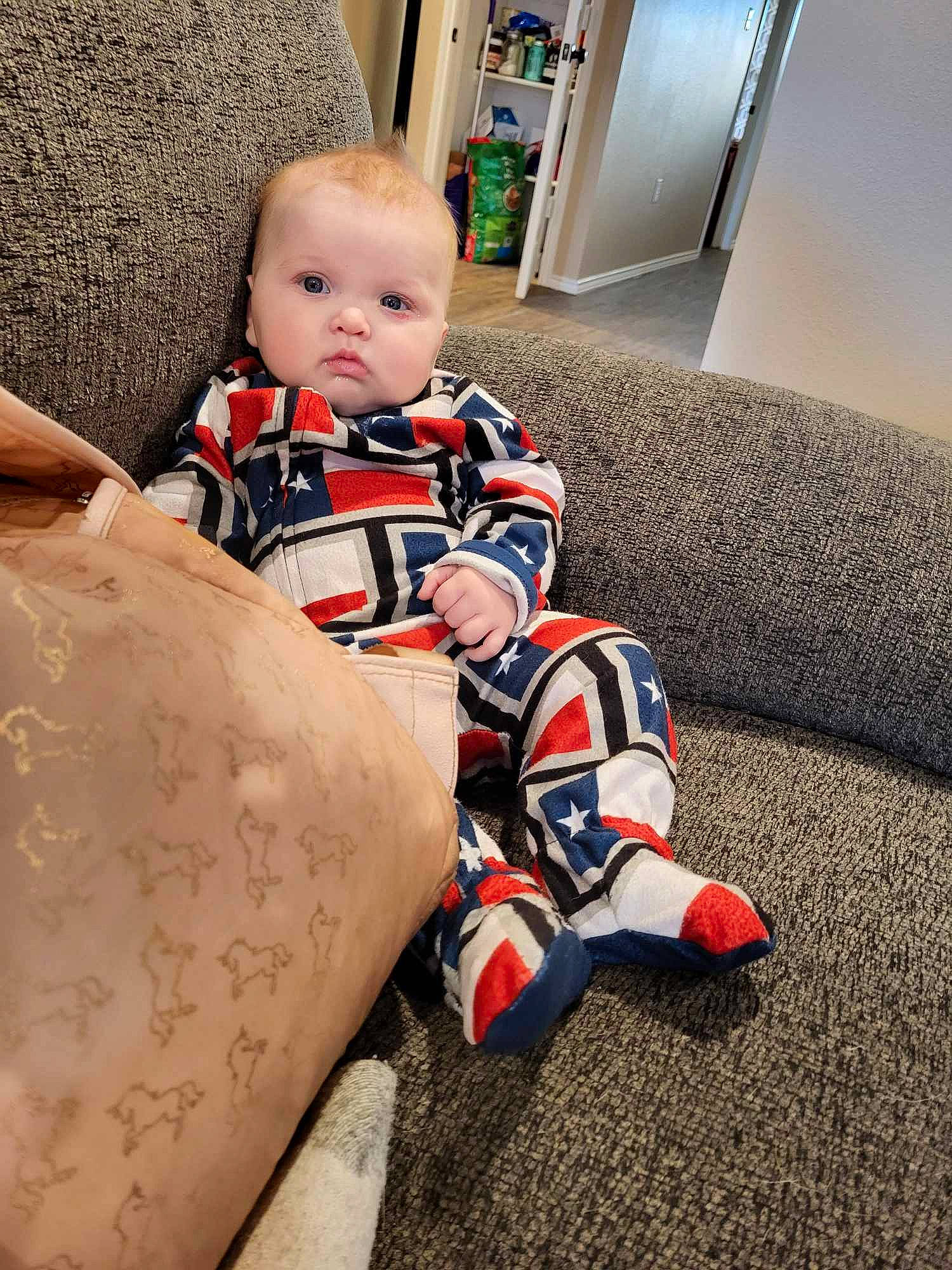 Avery is registered to the contest to win money with this photo: baby, baby_toddler_clothing, child, comfort, finger, flooring, human_body, joint, knee, leg, orange, pattern, person, skin, sleeve, sock, standing, textile, thigh, toddler