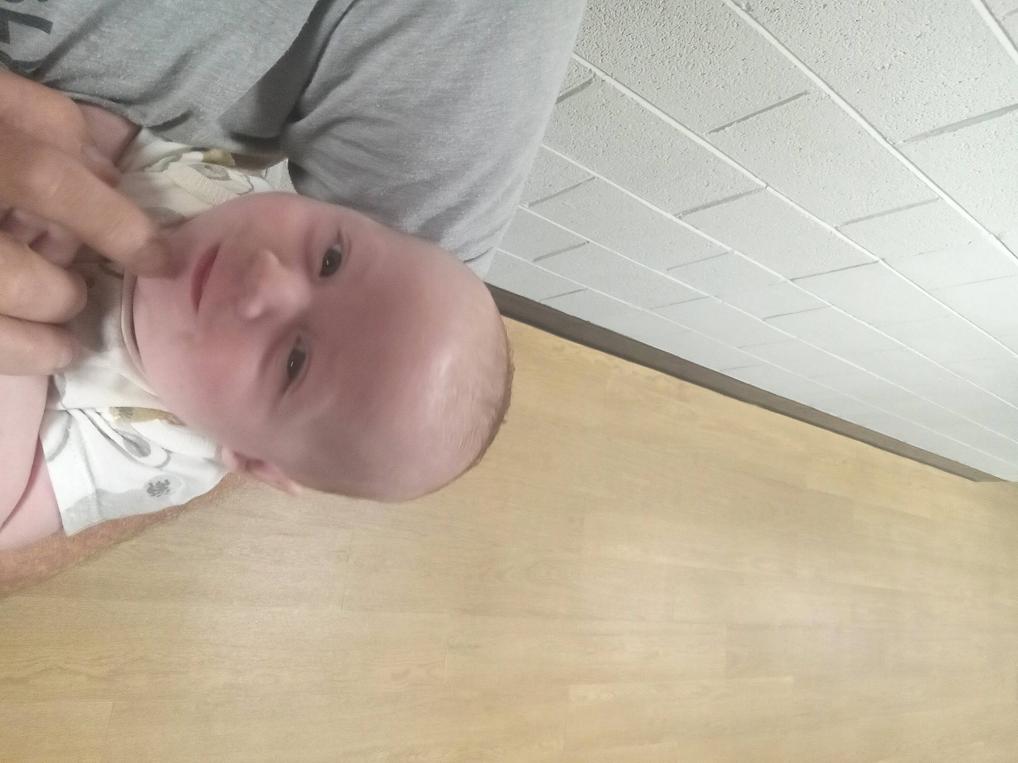 Austin is registered to the contest to win money with this photo: baby, baby_toddler_clothing, cheek, chest, child, comfort, elbow, eyebrow, eyelash, flooring, gesture, hardwood, human_body, nail, neck, nose, person, sleeve, thumb, toddler