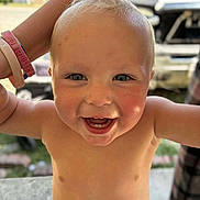 Country is registered to the contest to win money with this photo: toddler, child, smiling, happy, bare_chested, blond_hair, blue_eyes, outdoor, person, face, skin, expression, joy, hair, arm, wristbands, diaper, closeup, daylight, background_blur