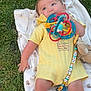 baby, grass, blanket, toy, onesie, pacifier_clip, outdoor, child, person, infant, cute, colorful, lying_down, happy, blue_eyes, chewing, soft_toy, nature, playtime, summer