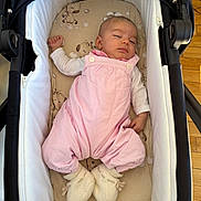 Sadia participe au concours pour gagner de l'argent avec cette photo : baby, infant, sleeping, bassinet, pink_clothing, knitted_booties, soft_padding, wooden_floor, indoors, peaceful, child, cute, resting, newborn, person, portrait, cozy, sleepwear, baby_clothes, cuddly