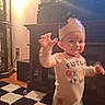Landon joined the competition — help win amazing prizes! toddler, child, paper_crown, indoor, living_room, toy, carpet, furniture, cabinet, smiling, waving, shirt, colorful_text, person, home, young_child, playful, cute, happy, blurred