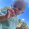 Landon joined the competition — help win amazing prizes! toddler, child, baby, hand, face, outdoor, sky, clouds, greenery, grass, daylight, expression, curious, casual_clothing, portrait, nature, person, blue_shirt, young_child, sunlight