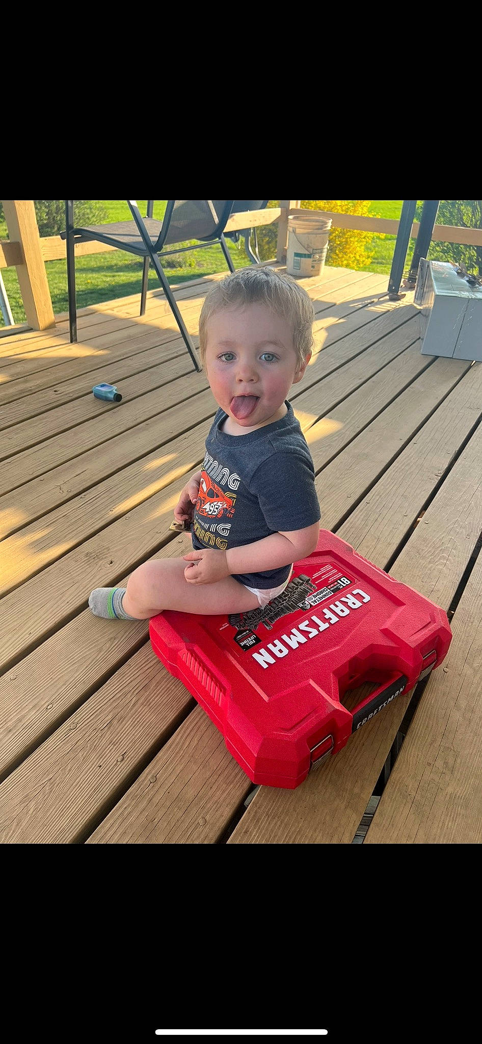 Carter joined the competition — help win amazing prizes! baby_toddler_clothing, carmine, child, deck, flooring, fun, grass, hardwood, leisure, logo, magenta, outdoor_furniture, person, play, recreation, sitting, smile, t_shirt, toddler, wood