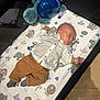 Djordan a rejoint le concours — aidez-le/la à gagner de superbes lots ! animal_print, baby, brown_pants, child, cozy, cute, floor, indoor, infant, mat, nursery, peaceful, playpen, plush_toy, resting, sleeping, sock, toy, turtle, white_shirt