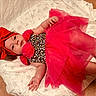 Oakleyy is registered to the contest to win money with this photo: baby, blanket, child, clothing, cozy, cute, foot, hand, headband, indoors, infant, leopard_print, lying_down, pink, portrait, red_bow, smiling, soft_texture, star_pattern, tutu