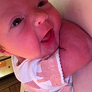 Oakleyy joined the competition — help win amazing prizes! baby, infant, smile, face, arm, onesie, patterned_clothing, bracelet, person, indoor, closeup, happy, skin, hand, cute, child, newborn, human, portrait, babywear