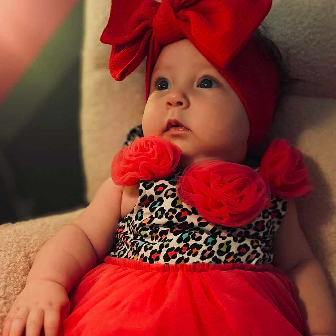 Oakleyy joined the competition — help win amazing prizes! adorable, baby, child, closeup, colorful, curious, cute, expression, face, fashion, headband, indoor, infant, leopard_print, portrait, red_bow, red_dress, sitting, soft_chair, young_child