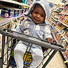 Demonte joined the competition — help win amazing prizes! baby, child, shopping_cart, hoodie, cozy_clothing, grocery_store, aisle, smile, happy, toddler, walgreens, retail, shopping, face, person, floor, shelf, packaging, indoor, casual