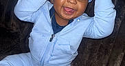 Demonte is registered to the contest to win money with this photo: toddler, child, smiling, happy, sitting, cap, nike, tracksuit, blue_clothing, shoe, sneaker, indoor, couch, plush, person, face, portrait, cute, playful, jewelry