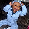 toddler, child, smiling, happy, sitting, cap, nike, tracksuit, blue_clothing, shoe, sneaker, indoor, couch, plush, person, face, portrait, cute, playful, jewelry