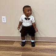 Demonte joined the competition — help win amazing prizes! black_shorts, bow_tie, child, cute, earrings, fashion, flooring, happy, indoor, jewelry, person, portrait, power_outlet, smiling, sneakers, standing, toddler, wall, white_shirt, wooden_floor