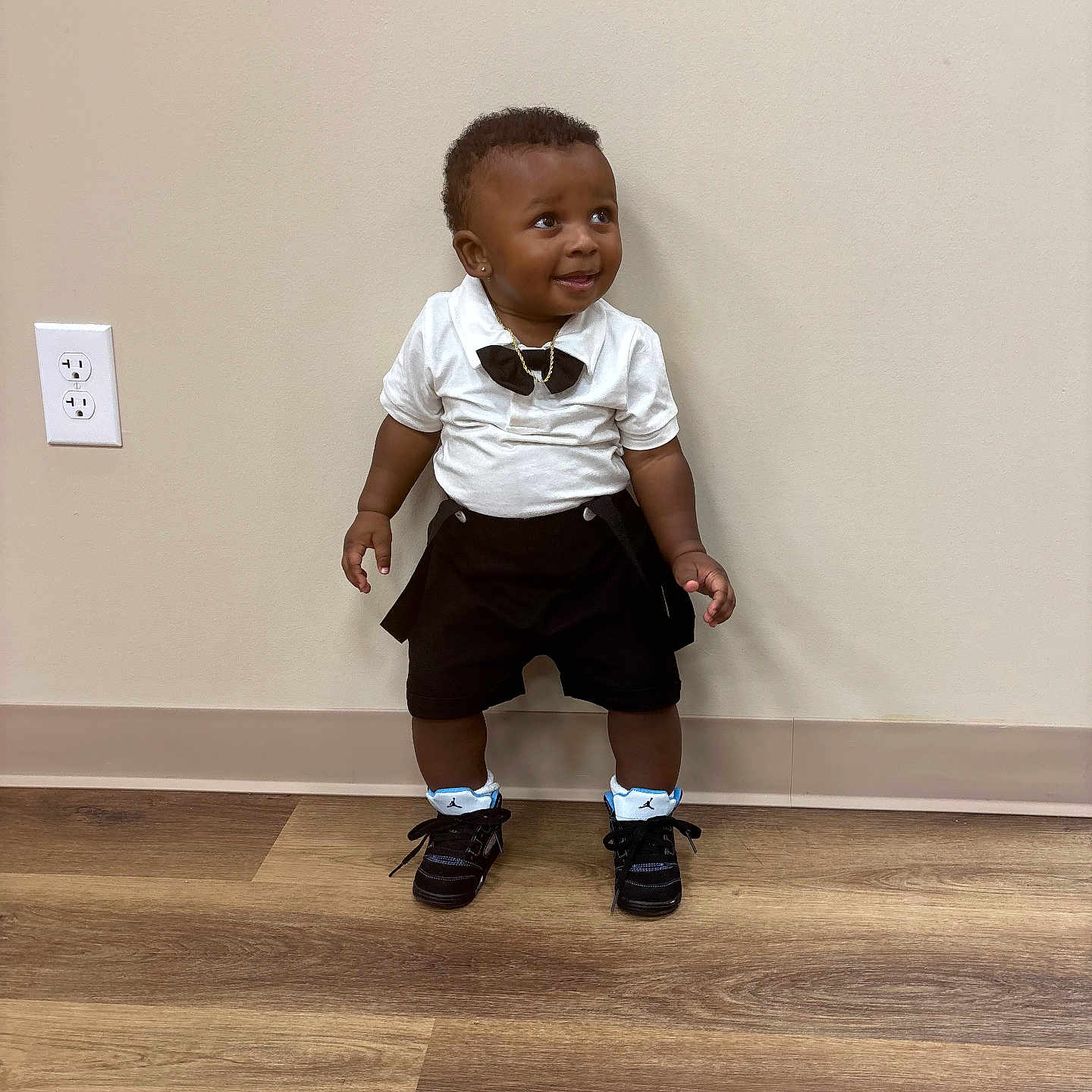Demonte joined the competition — help win amazing prizes! black_shorts, bow_tie, child, cute, earrings, fashion, flooring, happy, indoor, jewelry, person, portrait, power_outlet, smiling, sneakers, standing, toddler, wall, white_shirt, wooden_floor