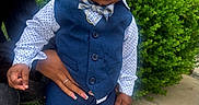 Demonte joined the competition — help win amazing prizes! toddler, child, boy, vest, bow_tie, shirt, pants, shoes, earring, hand, sidewalk, bush, outdoor, curly_hair, person, casual, fashion, portrait, standing, support