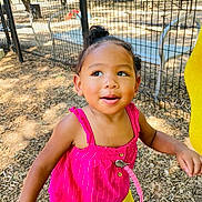 Xola joined the competition — help win amazing prizes! toddler, child, outdoor, playground, fence, sunlight, pacifier, pink_top, yellow_shorts, wood_chips, happy, smiling, person, daylight, cute, young_child, nature, park, casual_clothing, standing