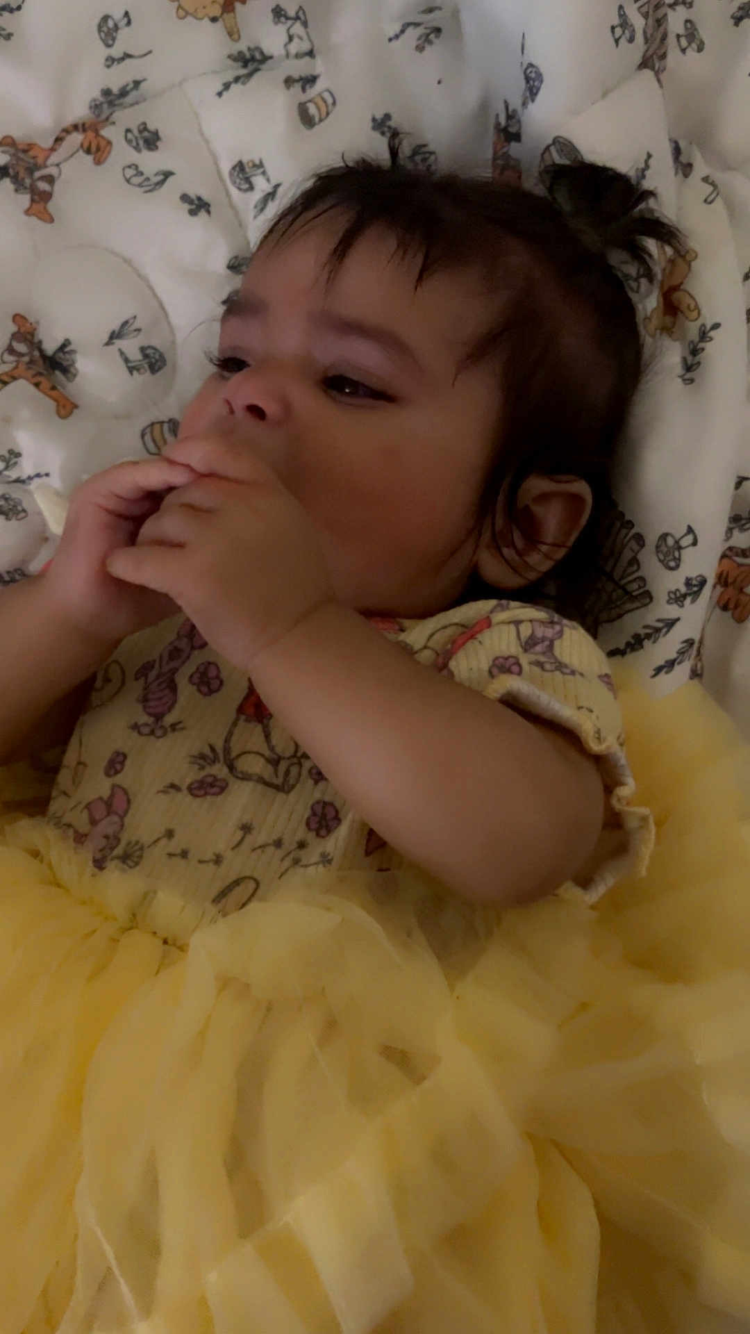 Nahomy is registered to the contest to win money with this photo: animal_print, baby, blanket, child, cute, dark_hair, expressive, face, hand, indoors, infant, lying_down, pattern, portrait, resting, small_hands, soft_lighting, tulle_skirt, yellow_dress, young_child