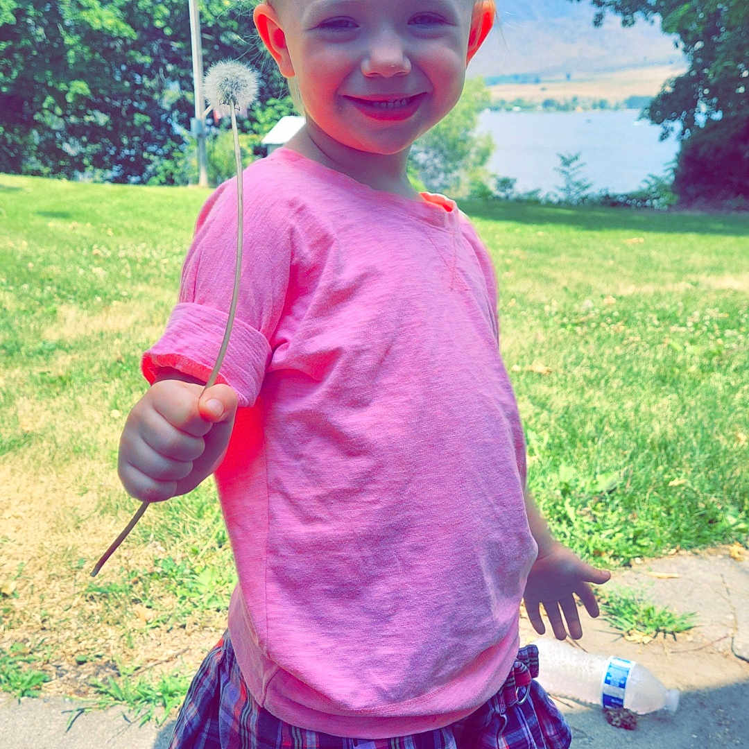 Cassi Rain is registered to the contest to win money with this photo: baby, bodypart, clothing, face, finger, grass, hand, head, nature, outdoors, park, person, photography, plant, portrait, shorts, skirt, summer, t_shirt, tree