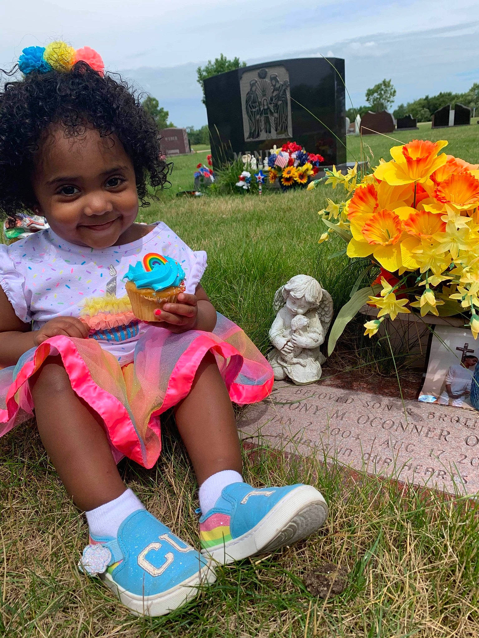 Sky is registered to the contest to win money with this photo: baby_toddler_clothing, event, flower, flower_arranging, fun, grass, grave, happy, human_leg, joy, leisure, person, petal, plant, recreation, shorts, sky, smile, sock, summer