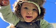 Waylen joined the competition — help win amazing prizes! baby, infant, child, smile, fur_hat, blue_sky, outdoors, reaching_hand, portrait, happy, eyes, cheeks, winter_clothing, onesie, held_up, sunlight, shadow, closeup, person, playful