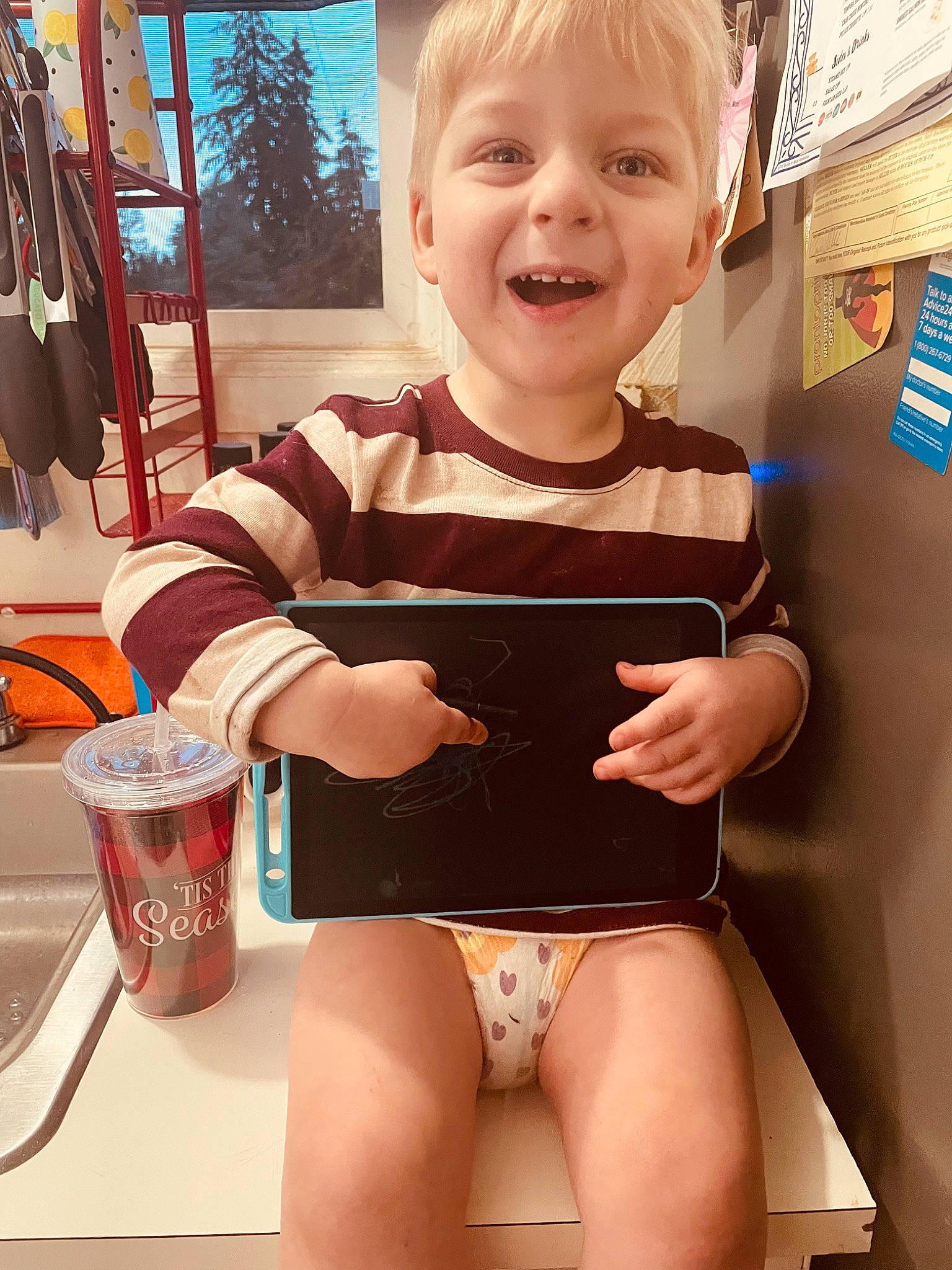 Paxton is registered to the contest to win money with this photo: baby_toddler_clothing, blond, child, finger, fun, hairstyle, hand, happy, human_body, human_leg, joy, knee, person, skin, sleeve, smile, standing, swimwear, t_shirt, thigh