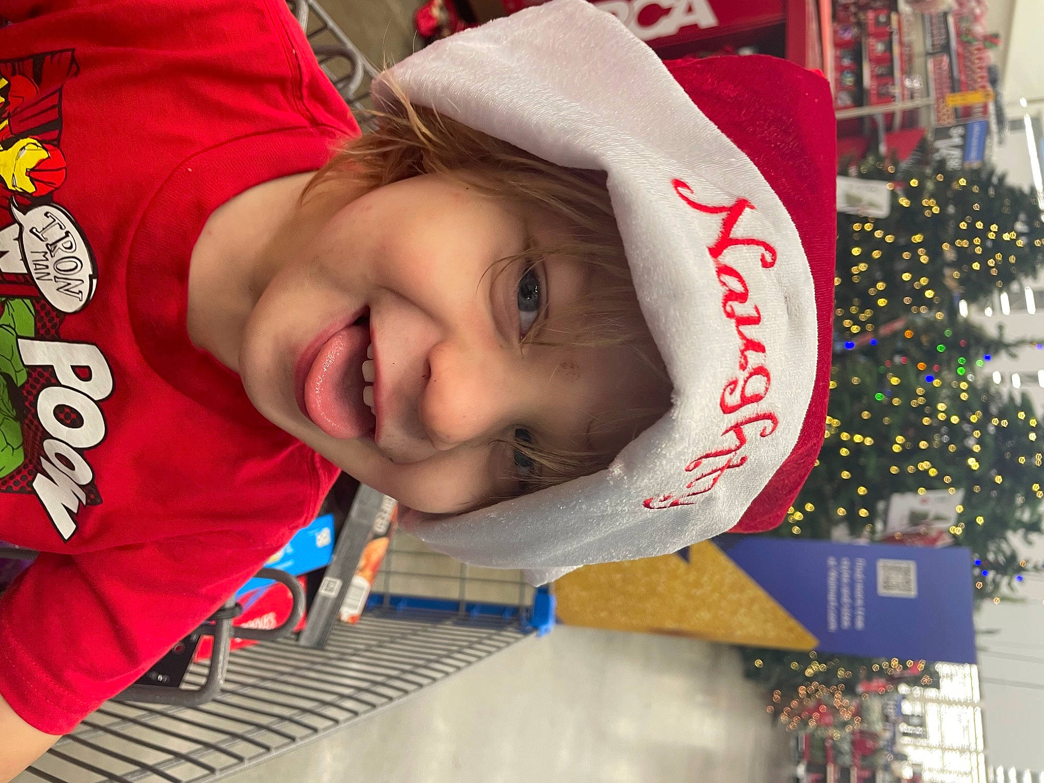 Paxton joined the competition — help win amazing prizes! carmine, child, christmas, christmas_decoration, christmas_eve, christmas_tree, event, facial_expression, fun, happy, headwear, holiday, holiday_ornament, joy, leisure, ornament, person, red, sleeve, smile