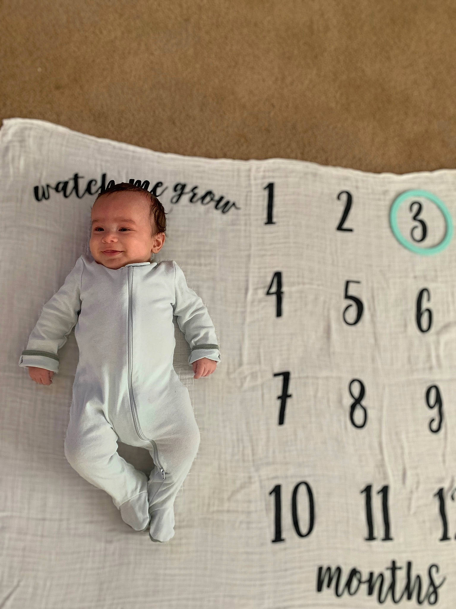 Kaizer is registered to the contest to win money with this photo: baby, baby_toddler_clothing, bedding, calendar, child, comfort, facial_expression, flooring, font, happy, linens, pattern, person, rectangle, sleeve, smile, suit, t_shirt, textile, throw_pillow