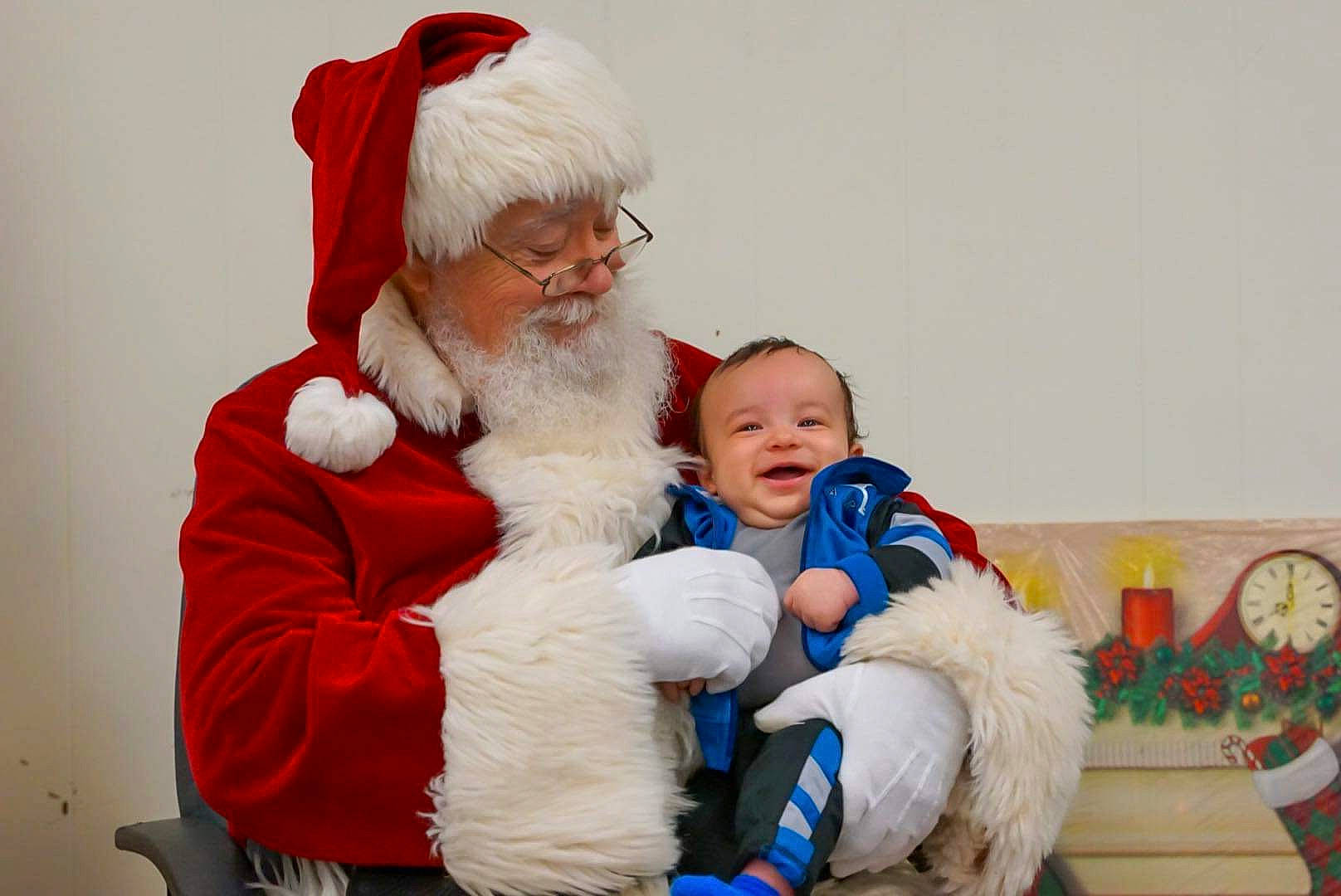 Kaizer joined the competition — help win amazing prizes! baby, beard, child, christmas, christmas_eve, costume_hat, event, facial_hair, fictional_character, fun, fur, happy, hat, holiday, lap, person, santa_claus, sitting, smile, toddler