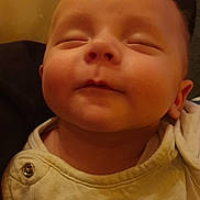 Andrea participe au concours pour gagner de l'argent avec cette photo : baby, infant, face, closed_eyes, sleeping, clothing, button, hand, skin, cute, peaceful, portrait, young_child, indoors, warm_lighting, head, expression, cozy, person, infant_clothing