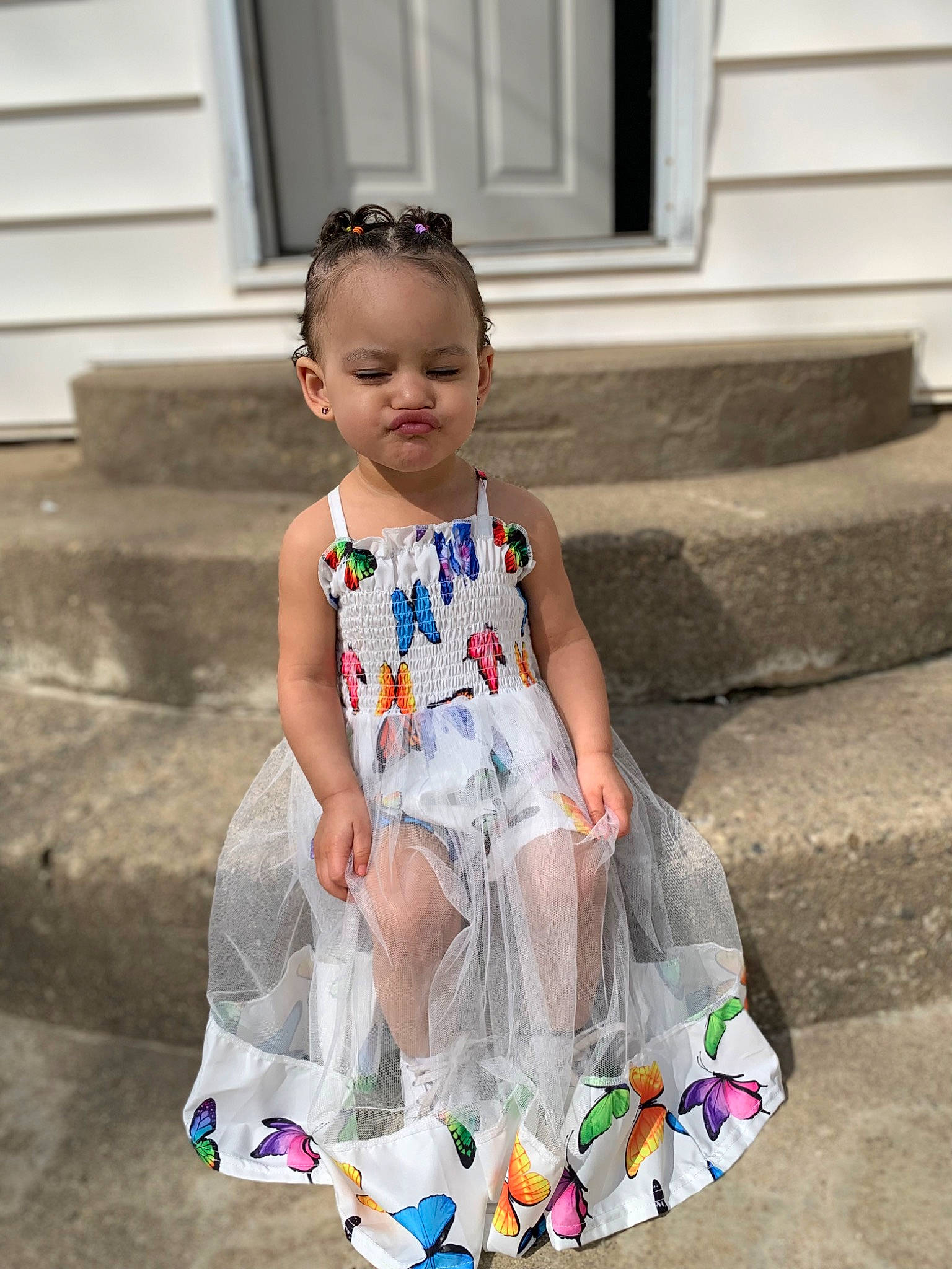Aniyah is registered to the contest to win money with this photo: baby_products, baby_toddler_clothing, child, door, dress, electric_blue, fashion_accessory, fun, happy, human_leg, leisure, pattern, person, pink, play, sandal, sitting, sleeve, t_shirt, toddler