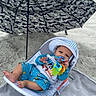 Xander joined the competition — help win amazing prizes! baby, beach, umbrella, toy, hat, shorts, blanket, sand, child, outdoor, sunshade, relaxing, smiling, blue_clothing, infant, seat, summer, sun_protection, colorful_toy, vacation