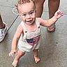 toddler, child, curly_hair, smiling, barefoot, outdoor, concrete, people, legs, sandals, white_shoes, clothing, flag_design, happy, walking, baby, person, summer, cute, innocent