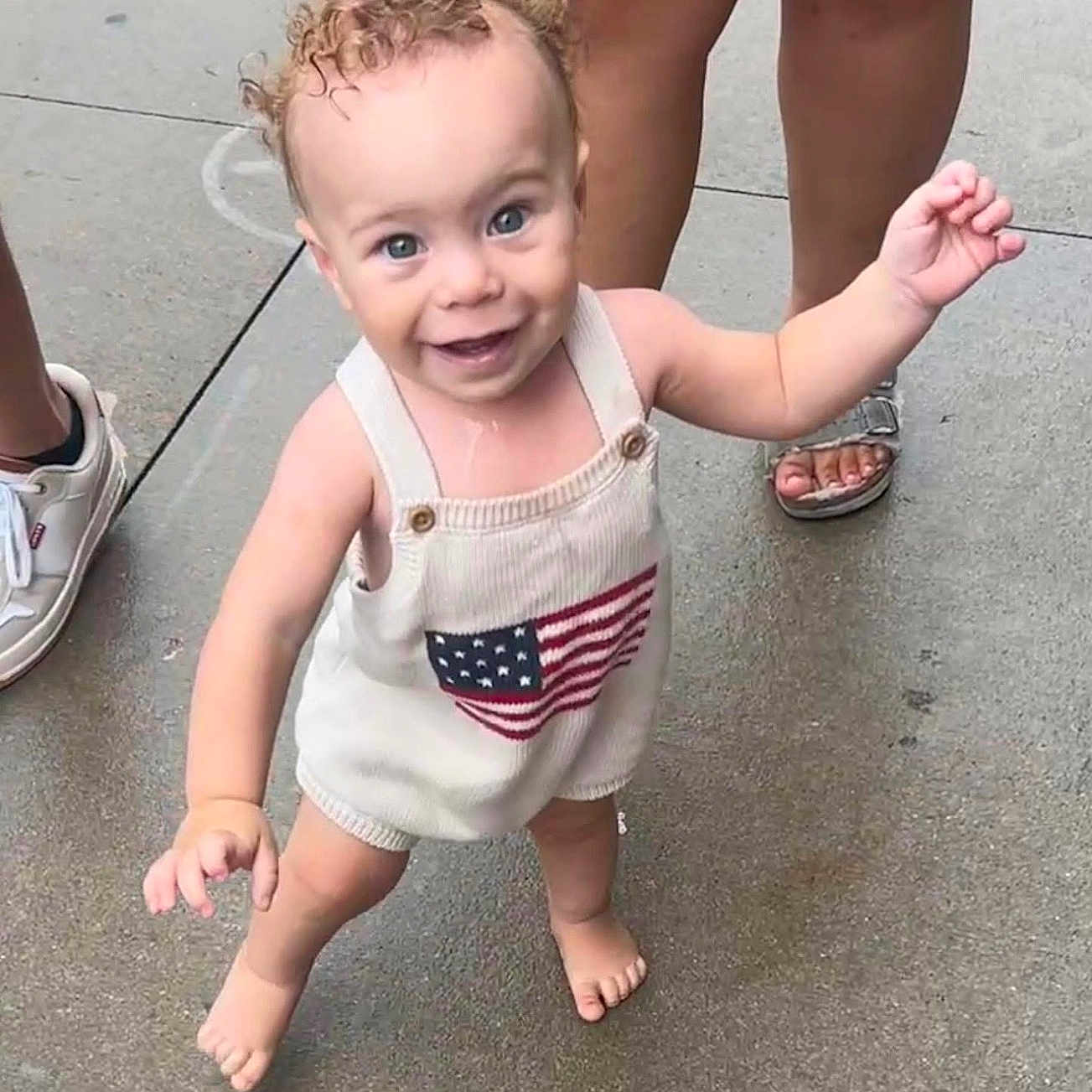 Nalo Martens joined the competition — help win amazing prizes! toddler, child, curly_hair, smiling, barefoot, outdoor, concrete, people, legs, sandals, white_shoes, clothing, flag_design, happy, walking, baby, person, summer, cute, innocent